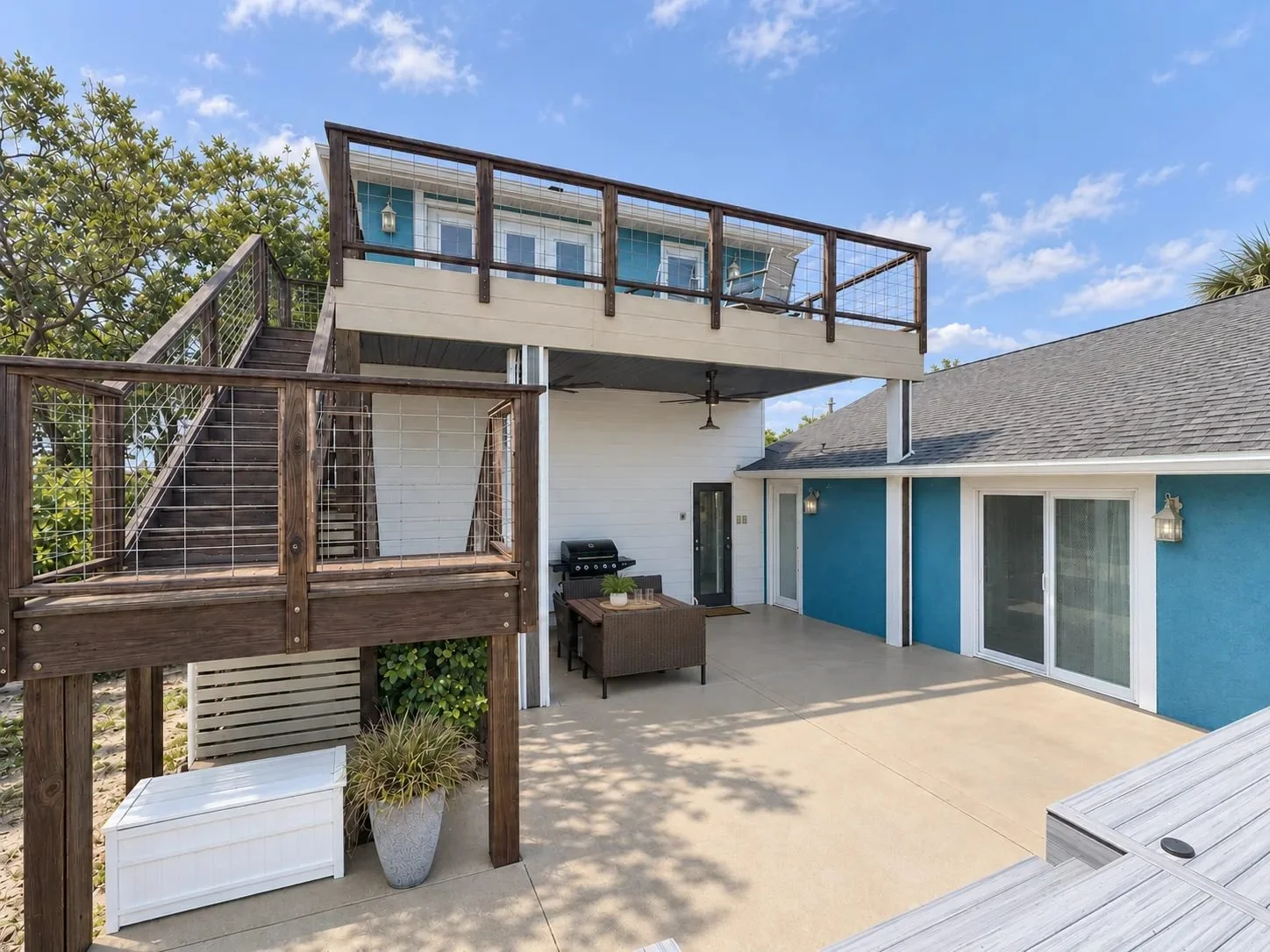 Sunny patio and upper deck beside the private pool at Opal Oasis