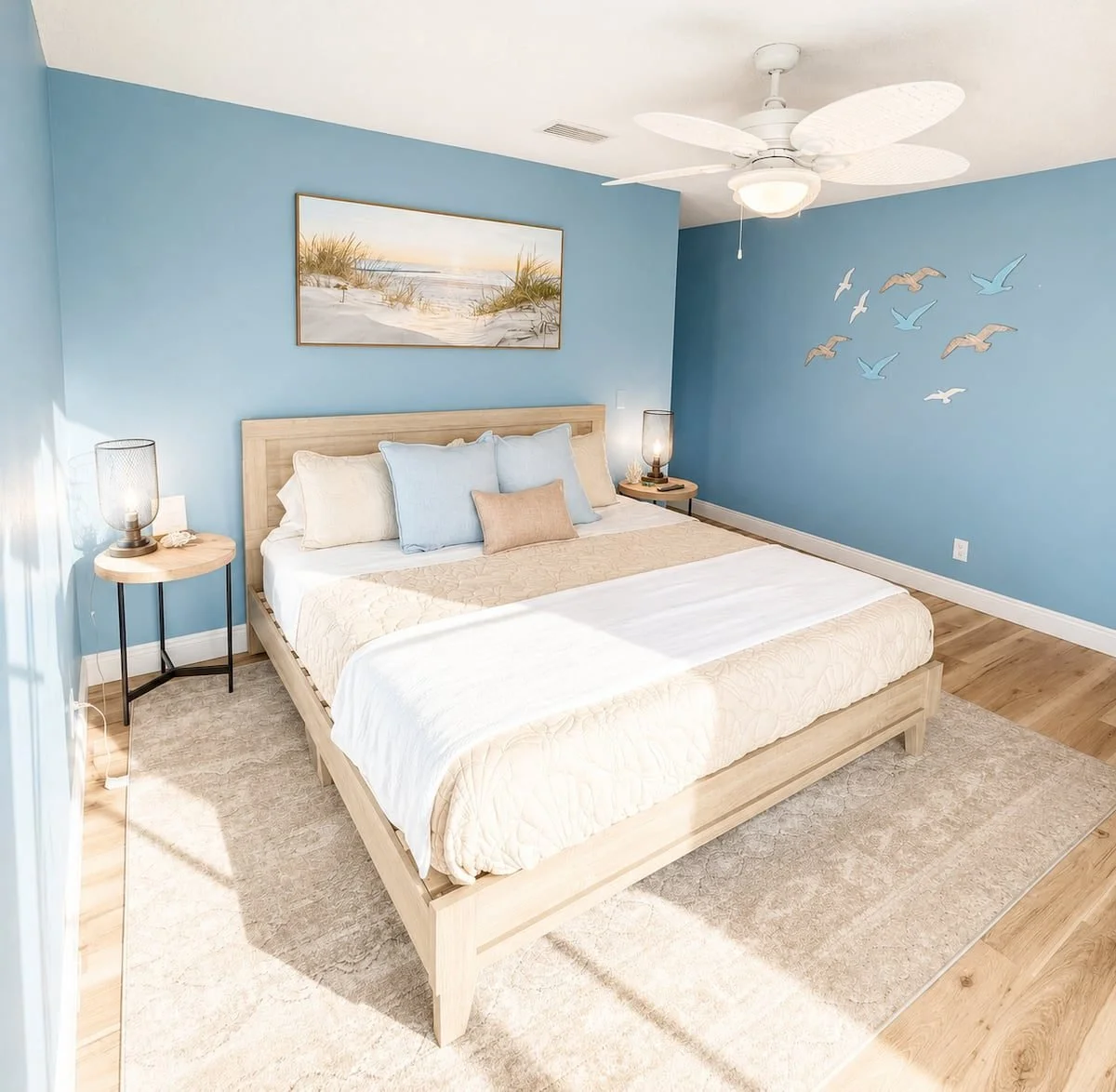 Bright king bedroom with blue walls and coastal decor