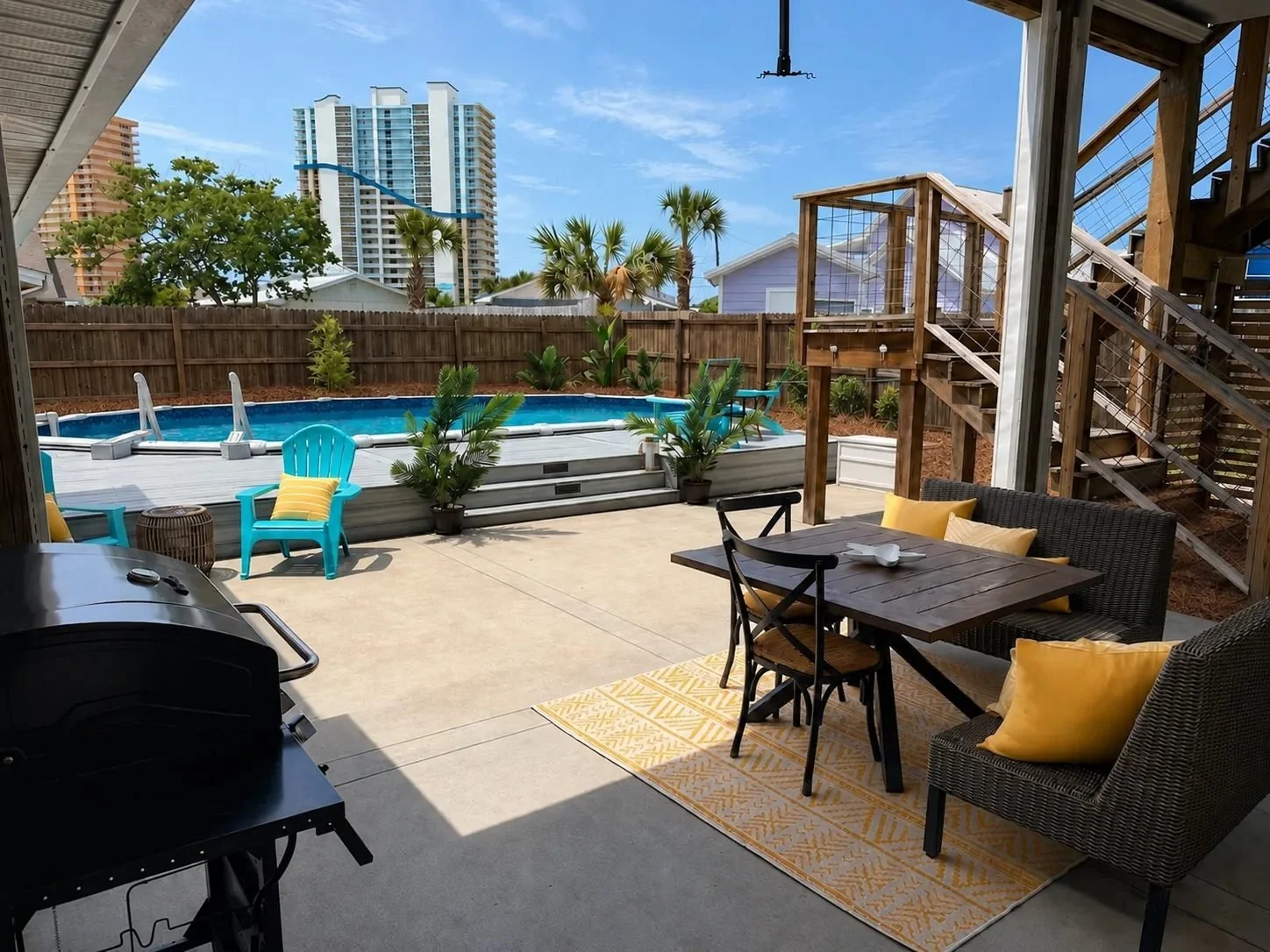 Backyard pool, outdoor dining area, wooden deck, and pine-straw landscaping