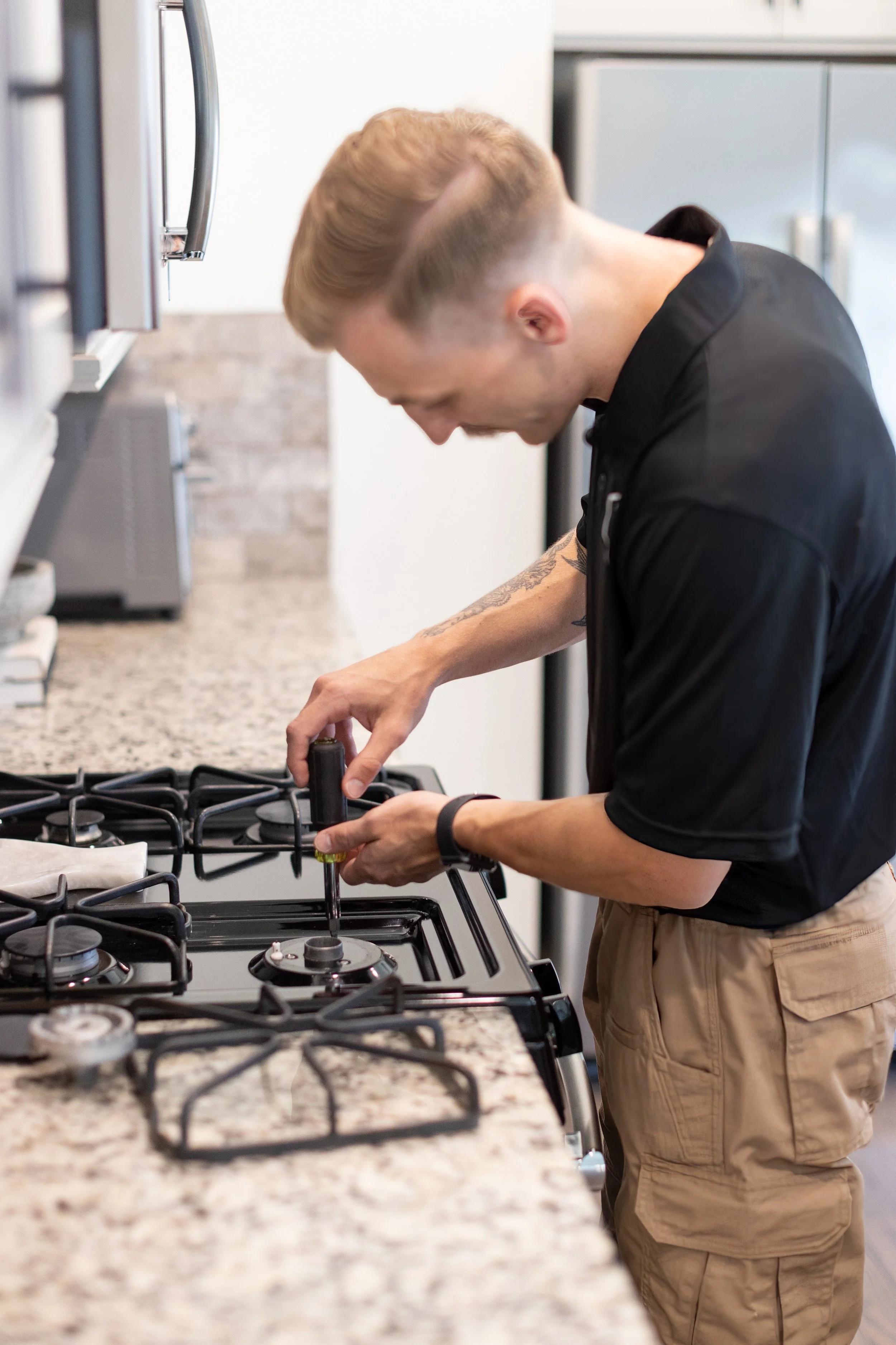 Aaron Tucker of Tucker Appliance Repair on a cooktop repair service call in Greater Birmingham