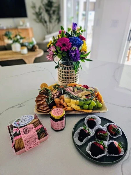 Flowers, charcuterie and chocolate covered strawberries delivered by Door 2 Door & More