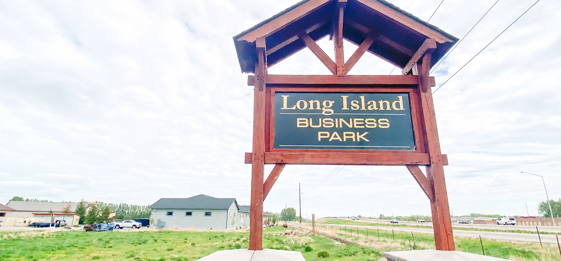 Timber-framed Long Island Business Park sign in Rigby, Idaho