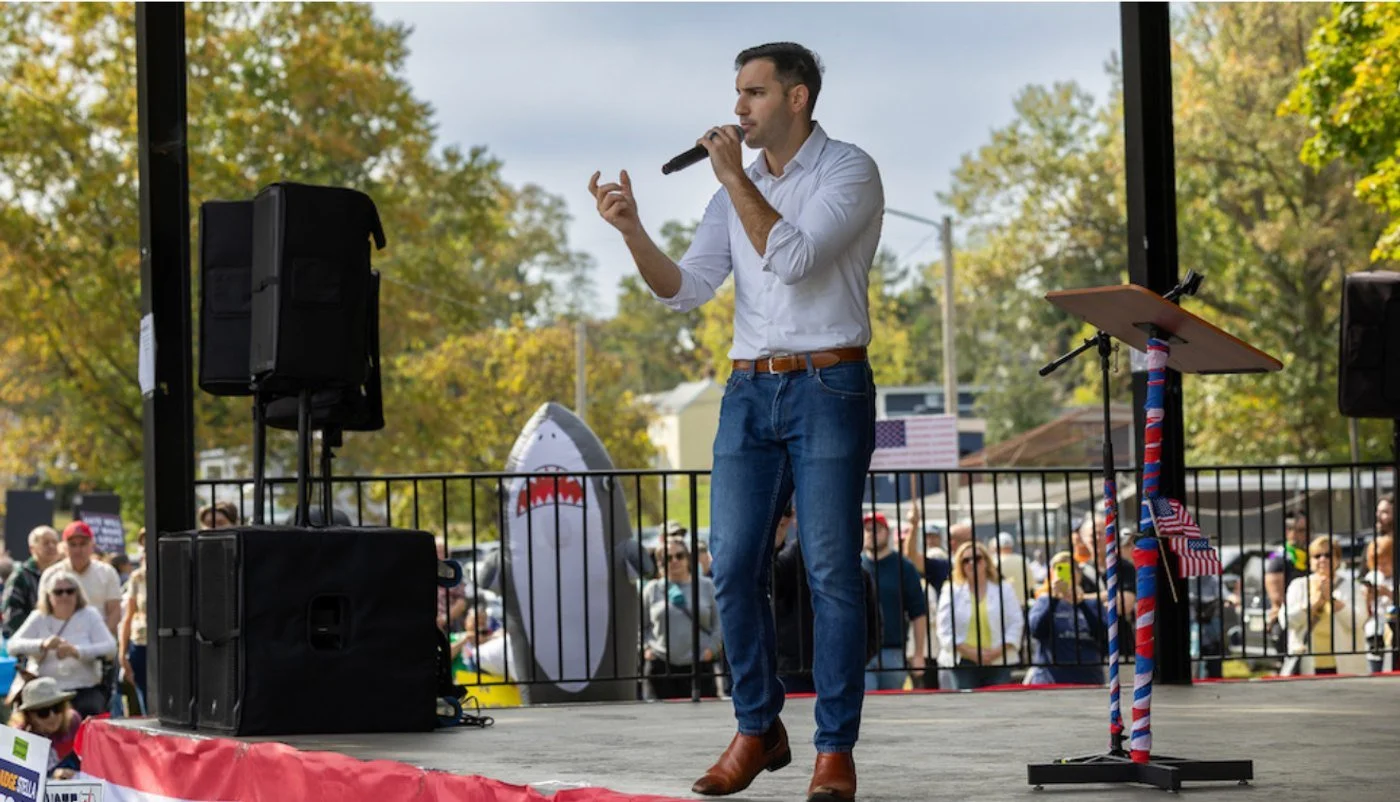 Danny Ceisler speaking on stage at a rally