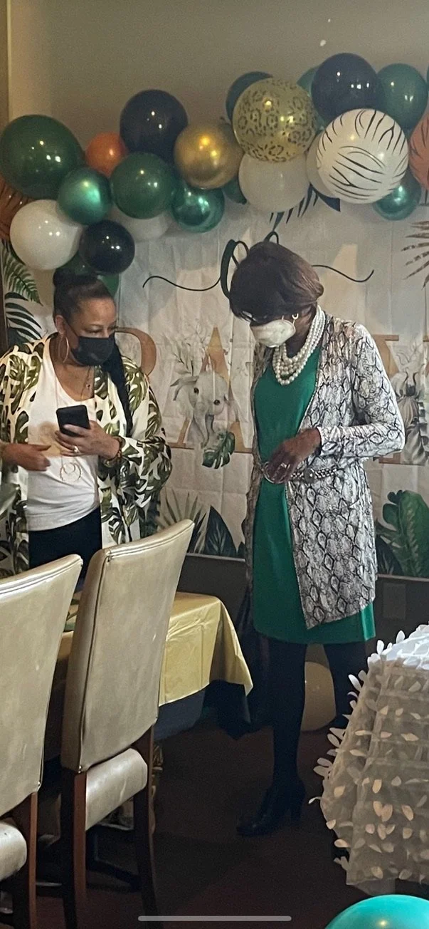 Ophelia with her sister Denise Woodard, looking at an outfit