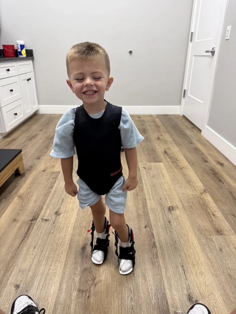 Archie standing in his leg braces