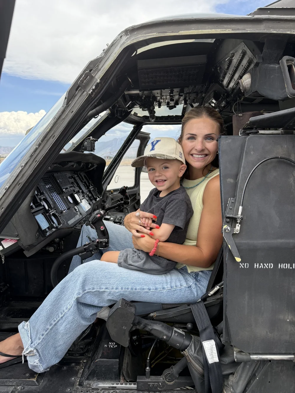 Archie with his mom in a helicopter cockpit