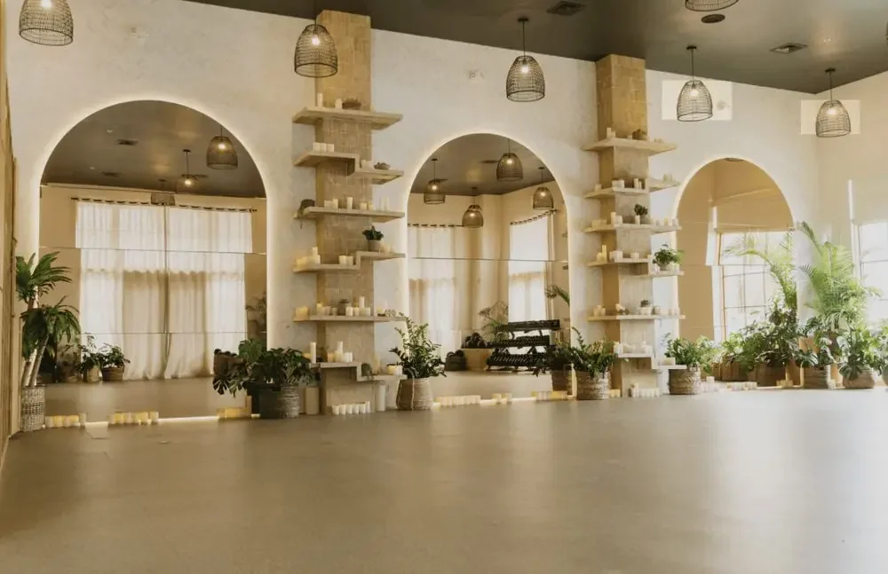 Jungle Pilates studio interior with arched mirrors and warm wood finishes