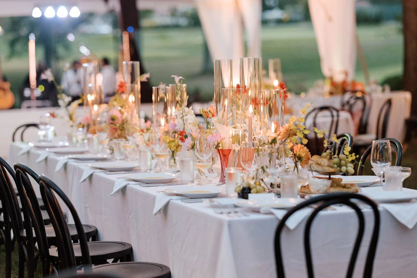 Candlelit wedding dinner table with expressive floral design