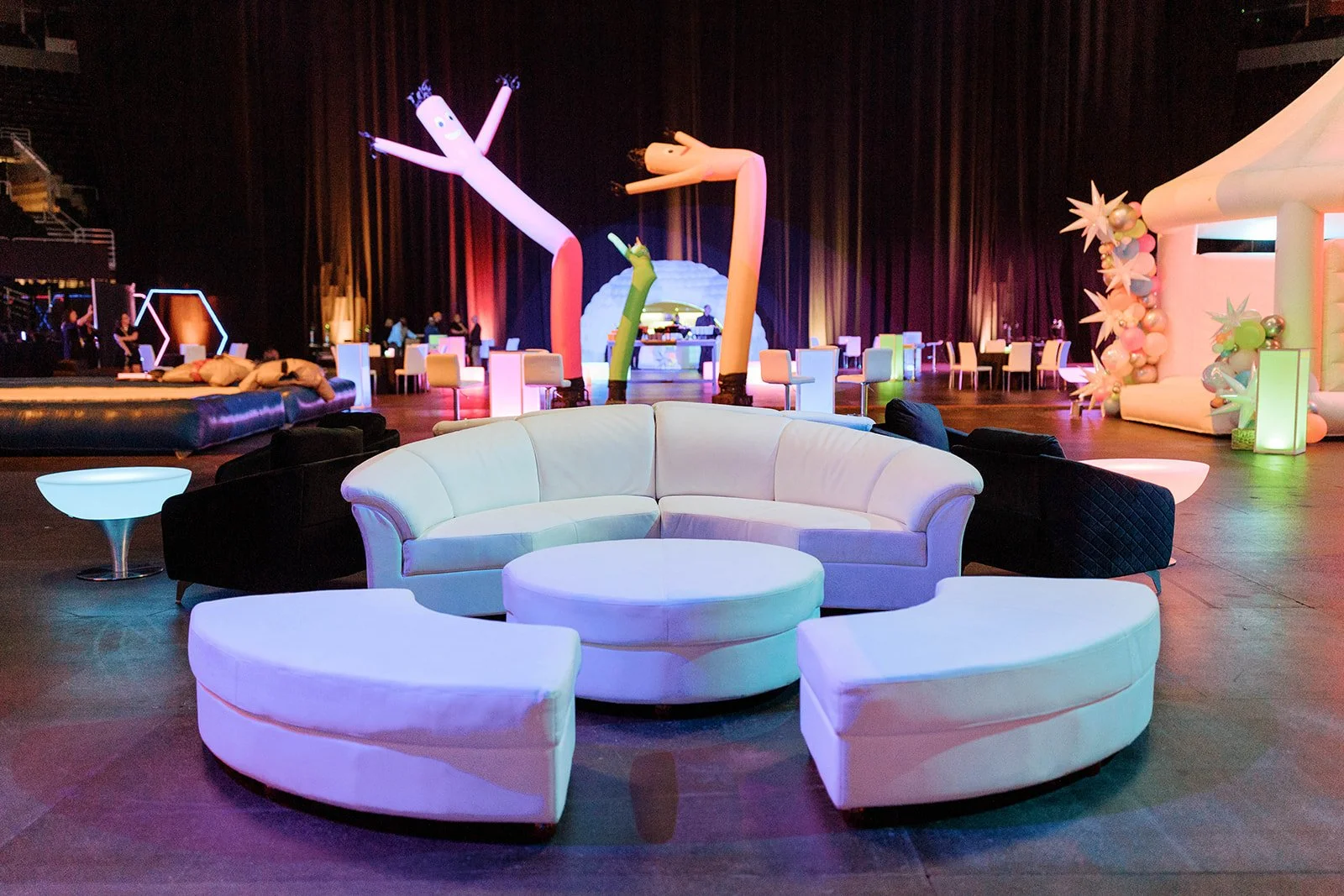Curved white lounge seating and glowing tables