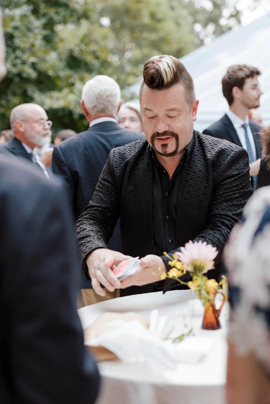 Close-up card entertainment at an outdoor reception
