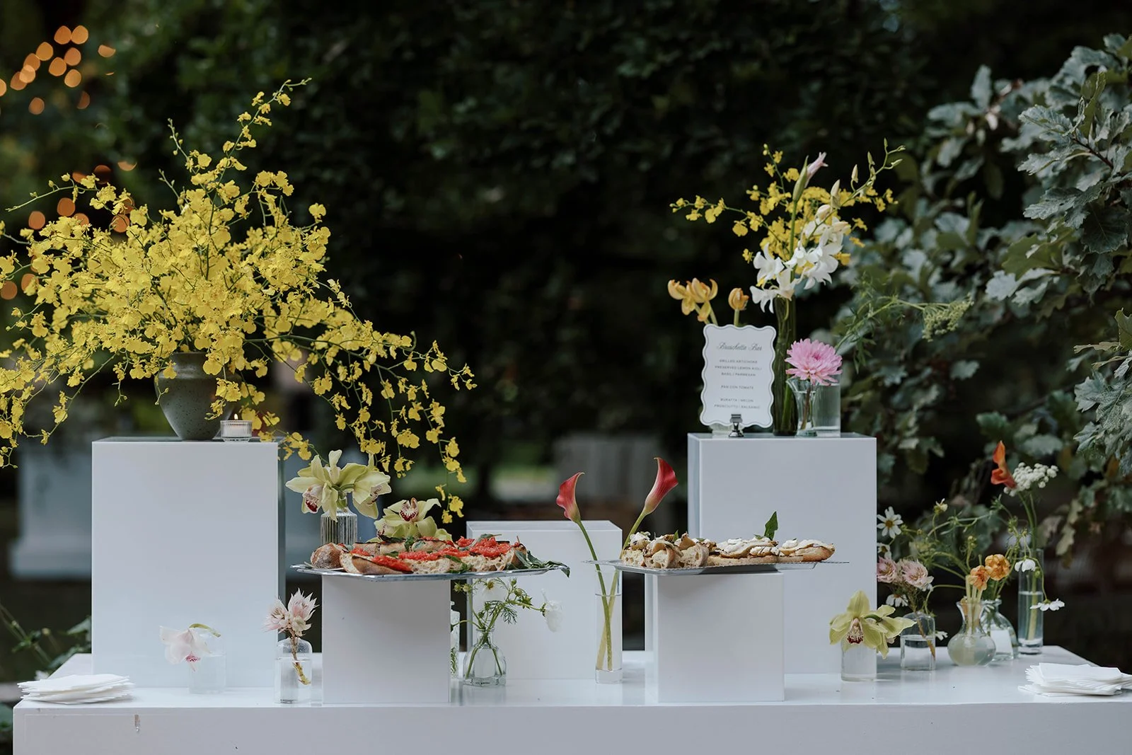 Sculptural catering display with yellow orchids and fresh flowers