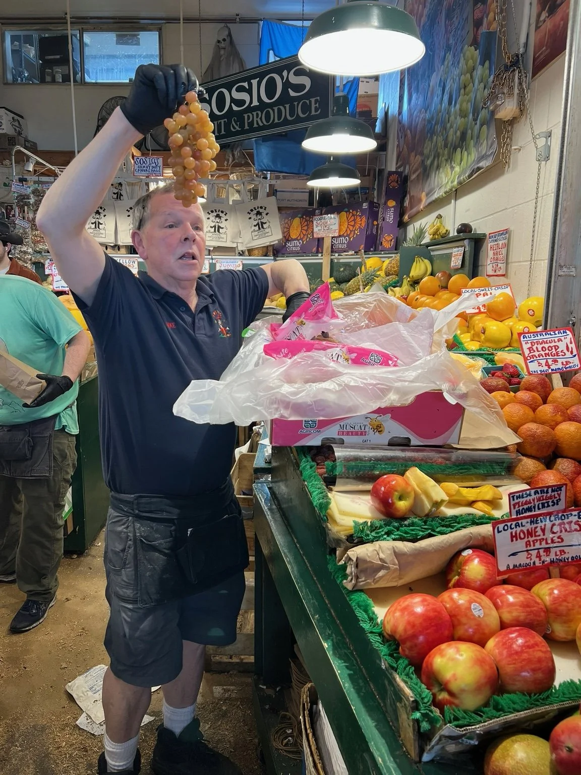 A produce vendor showing fresh fruit at Pike Place Market
