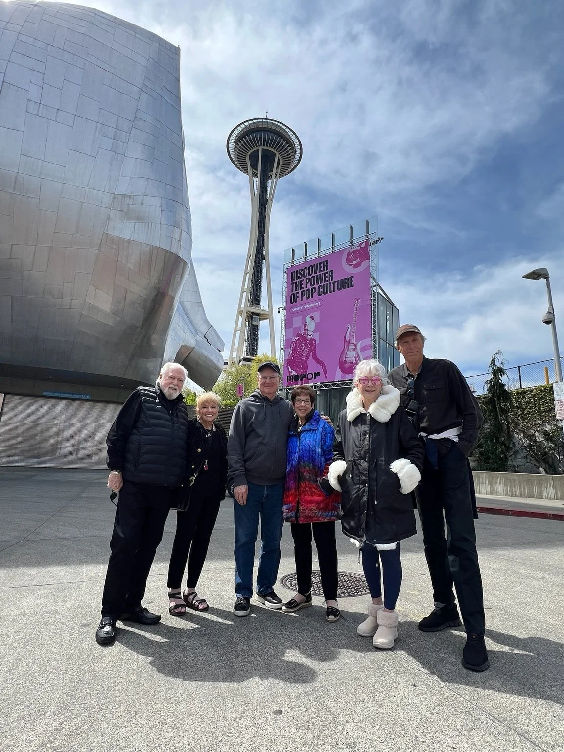 A Cascade tour group together at Seattle Center beneath the Space Needle