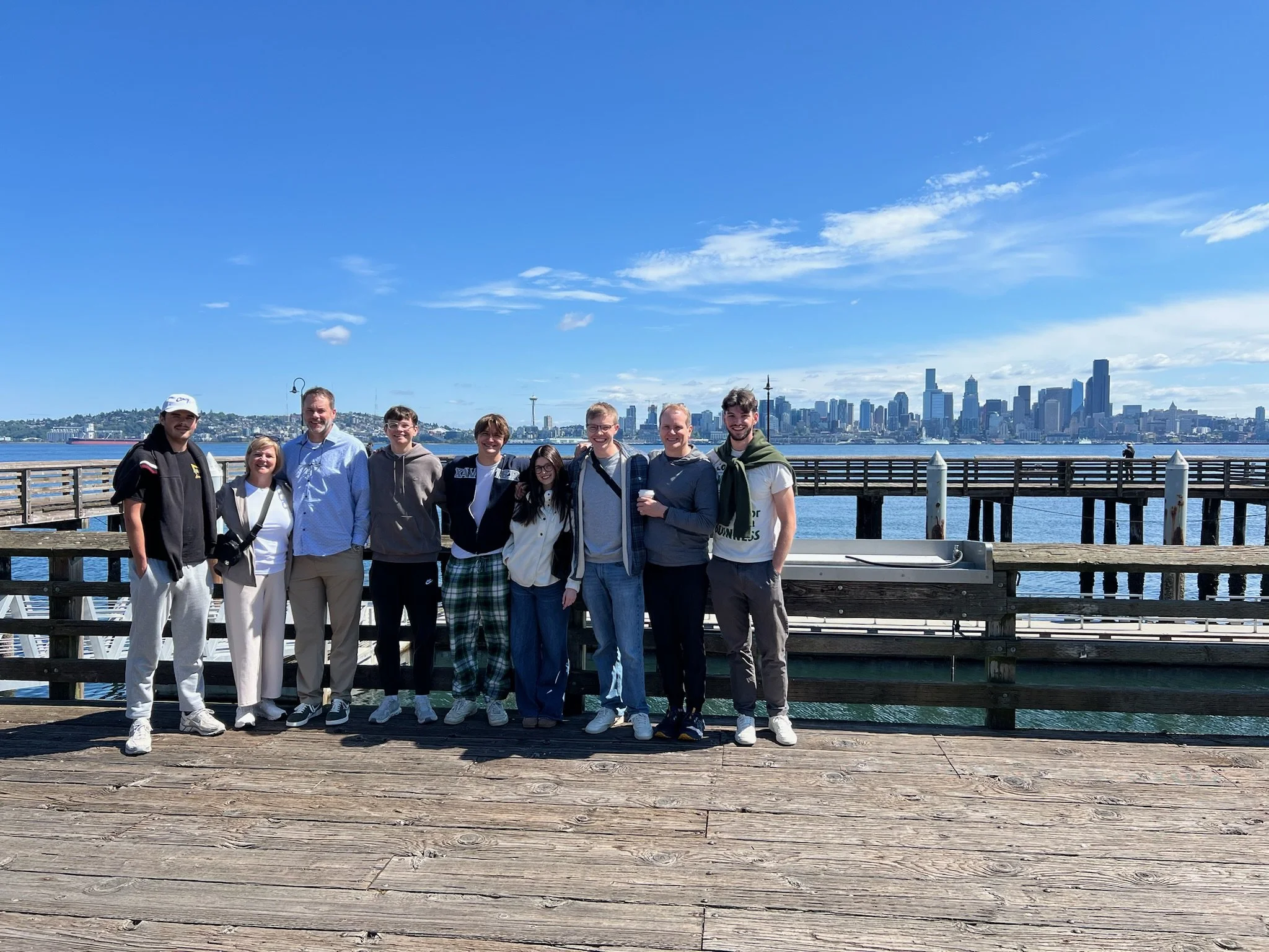 A group of Cascade guests beside the water with the Seattle skyline across Elliott Bay