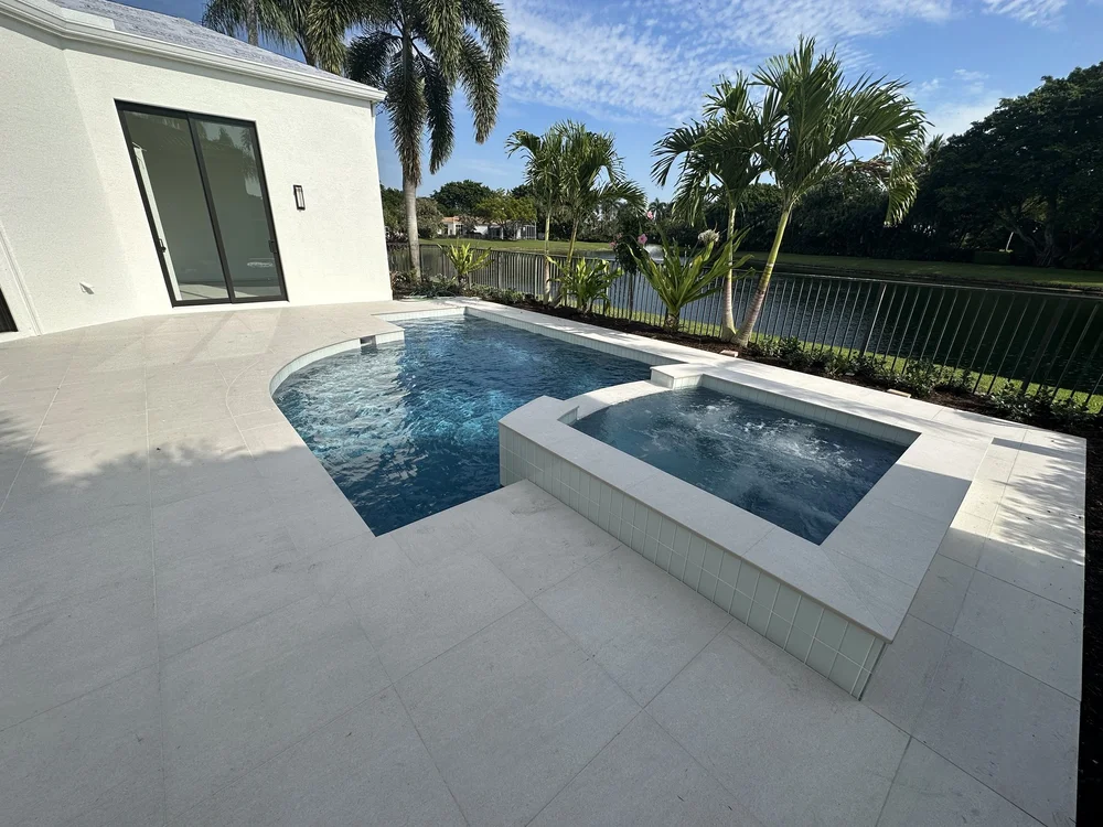 New gunite pool with a raised spa and white pergola