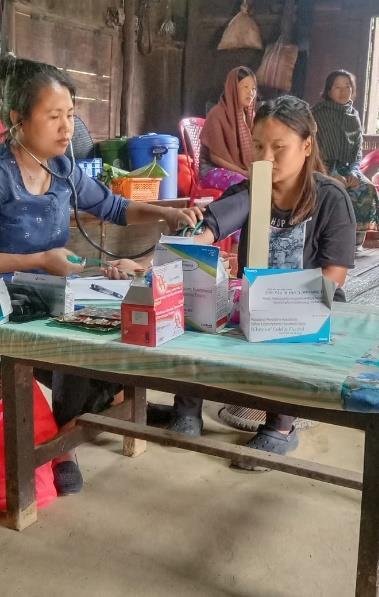A nurse taking a woman's blood pressure during NARUDA's health education programme in Nagaland
