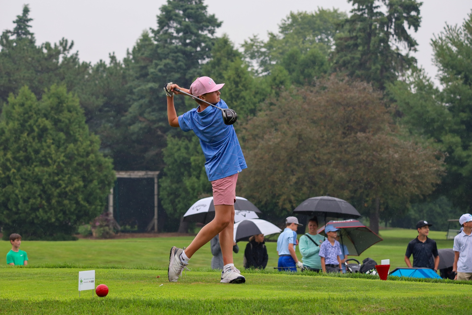 Junior golfer tees off during an Elevate Junior Tour event