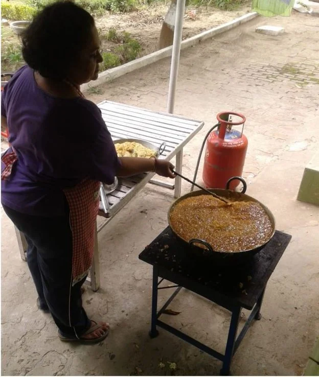 Pickle cooking in a large kadhai