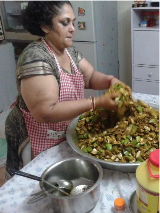 Pickle being mixed by hand in a large bowl