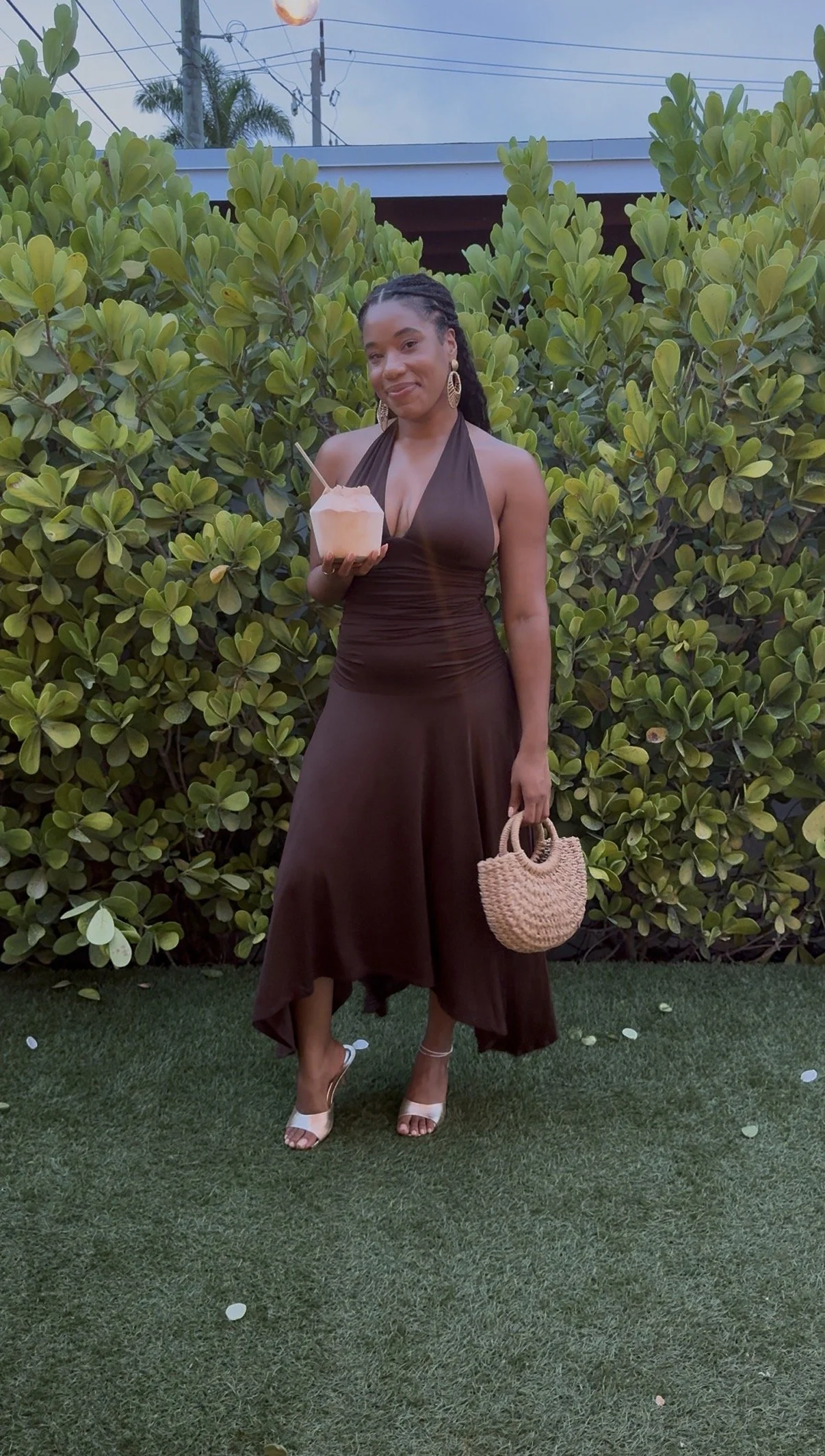 Ley wearing a brown dress