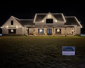 Warm white holiday lights on a farmhouse