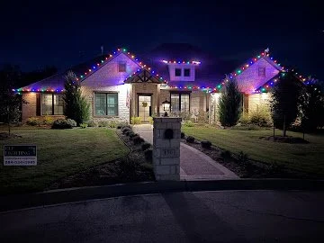 Colorful roofline lights on a home