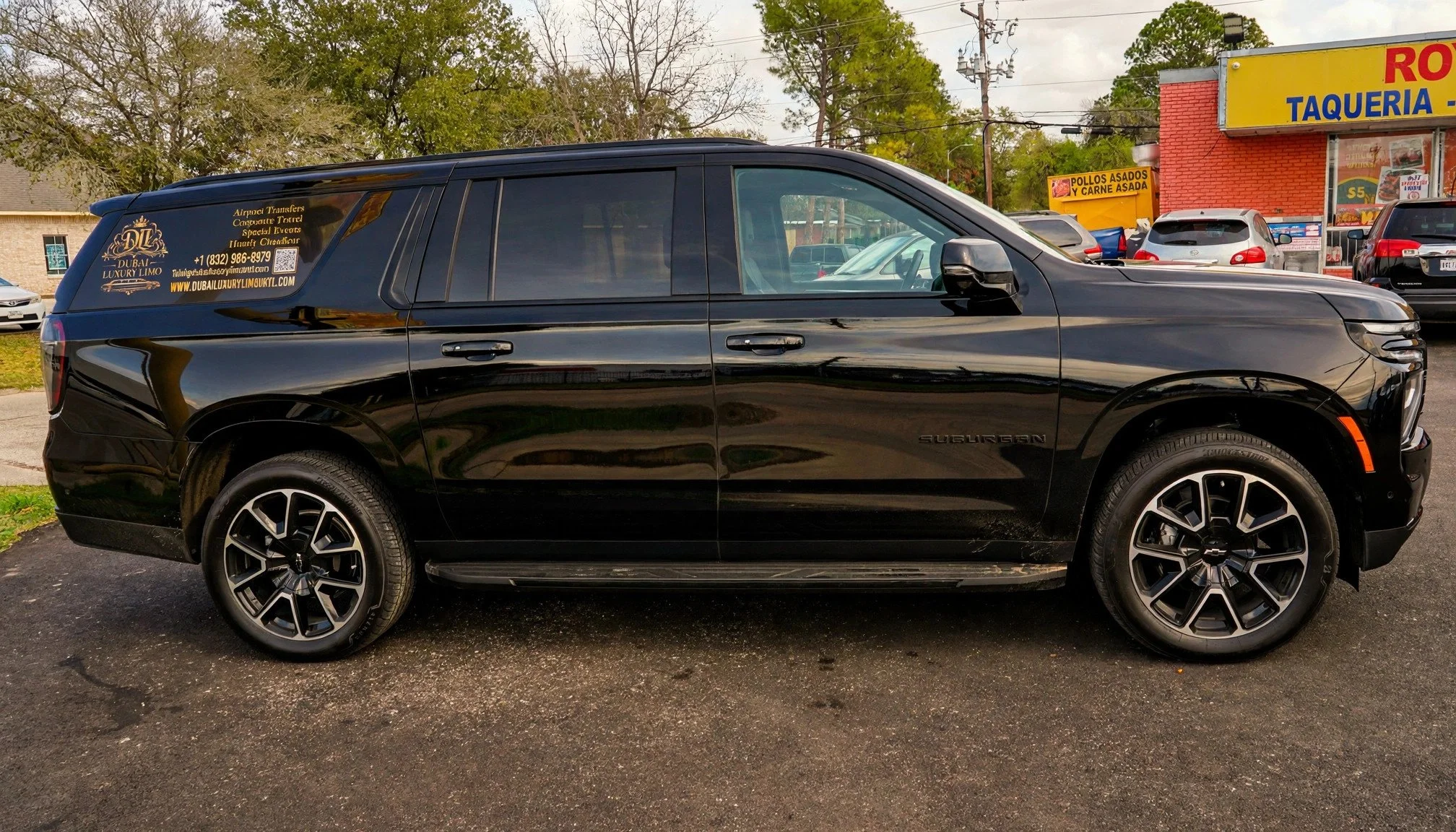 Side view of the branded black Chevrolet Suburban