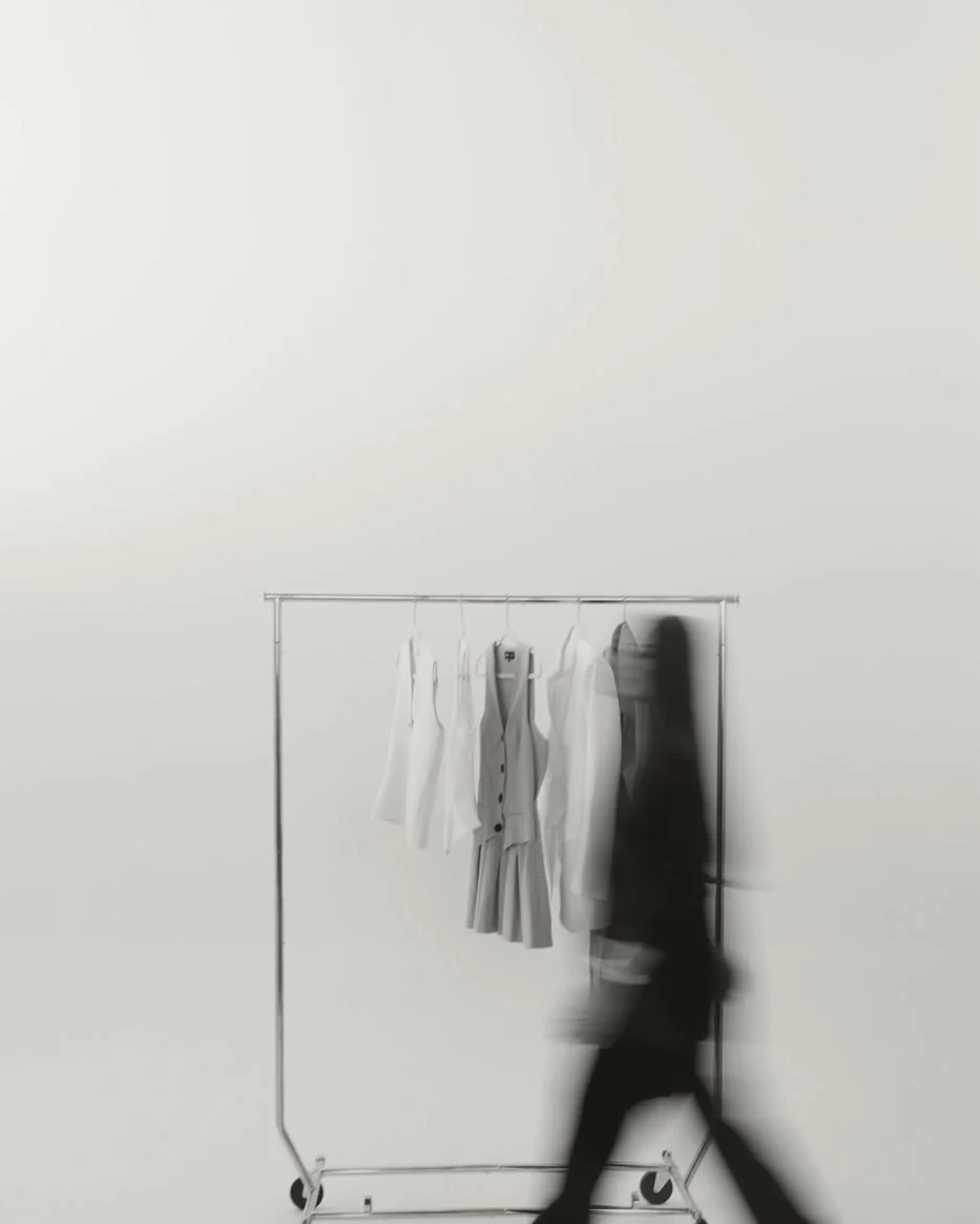 Motion blur of Nicole Marcus walking past a clothing rack