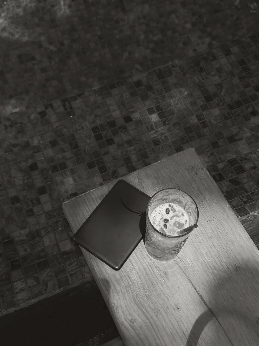 Iced drink and notebook on a table