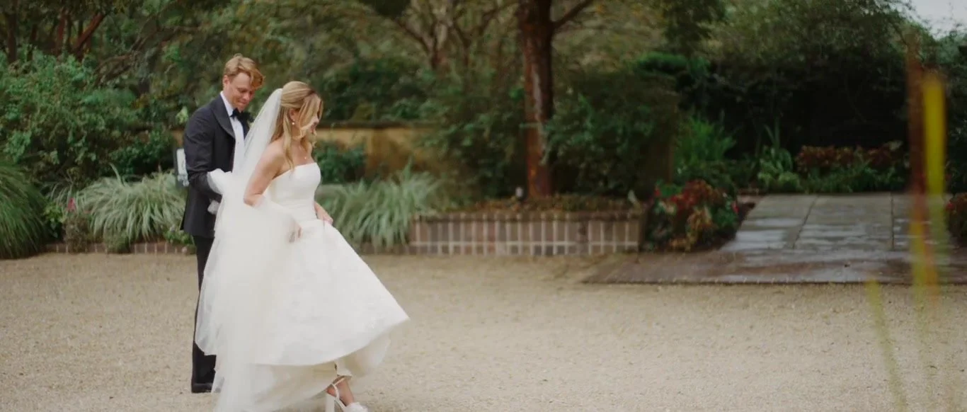 Lane and Tyler turning together in a lush garden