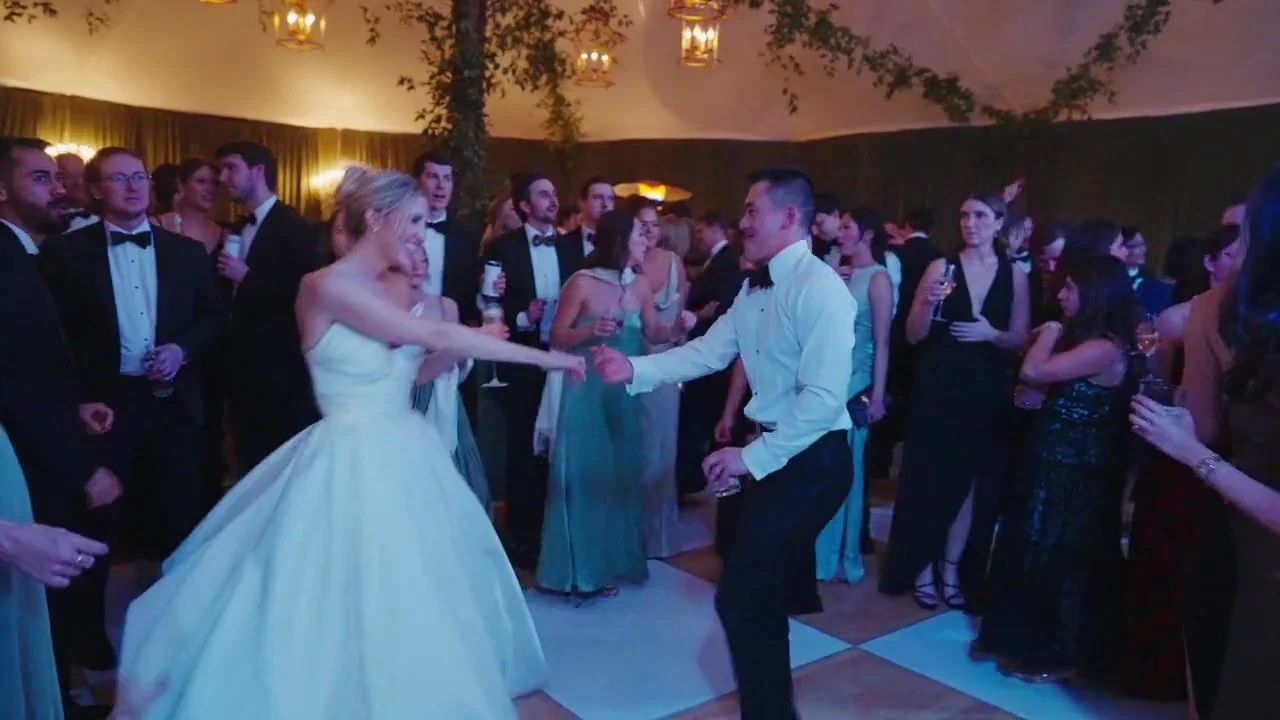 Juliette and Billy celebrating on the dance floor surrounded by guests