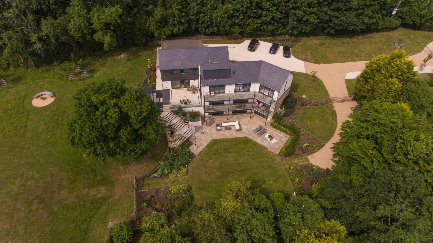 An aerial view of The Paddocks showing the terraces and planted garden spaces around the house.