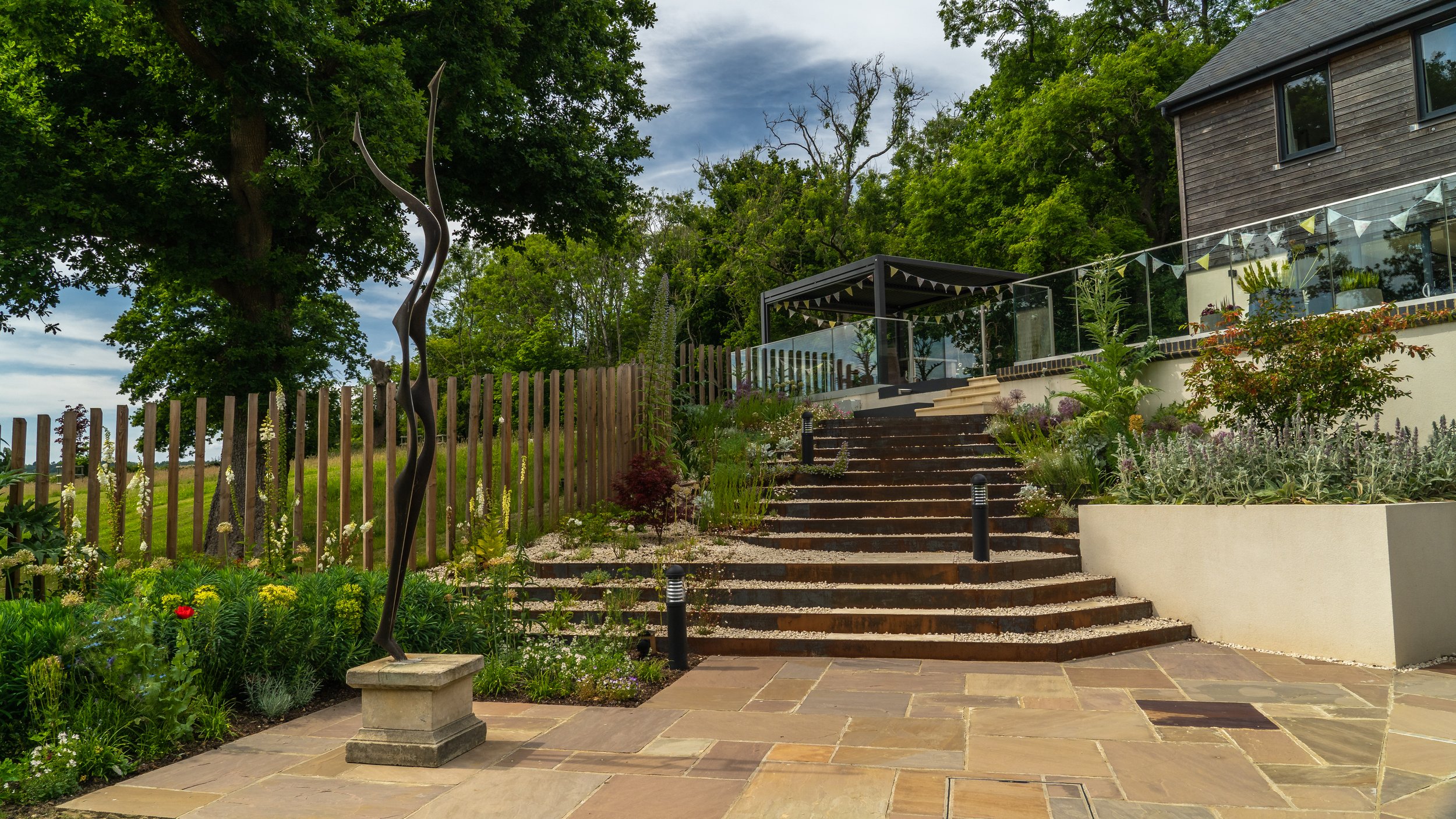 Cascading steps and planting connect the home and garden at The Paddocks.