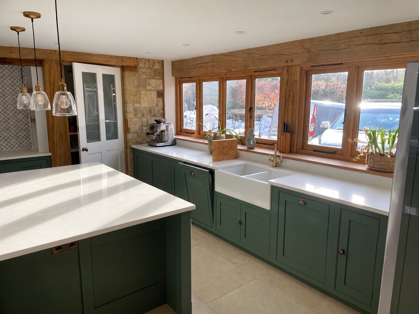 Timber-framed windows, stonework and daylight in the reworked kitchen.
