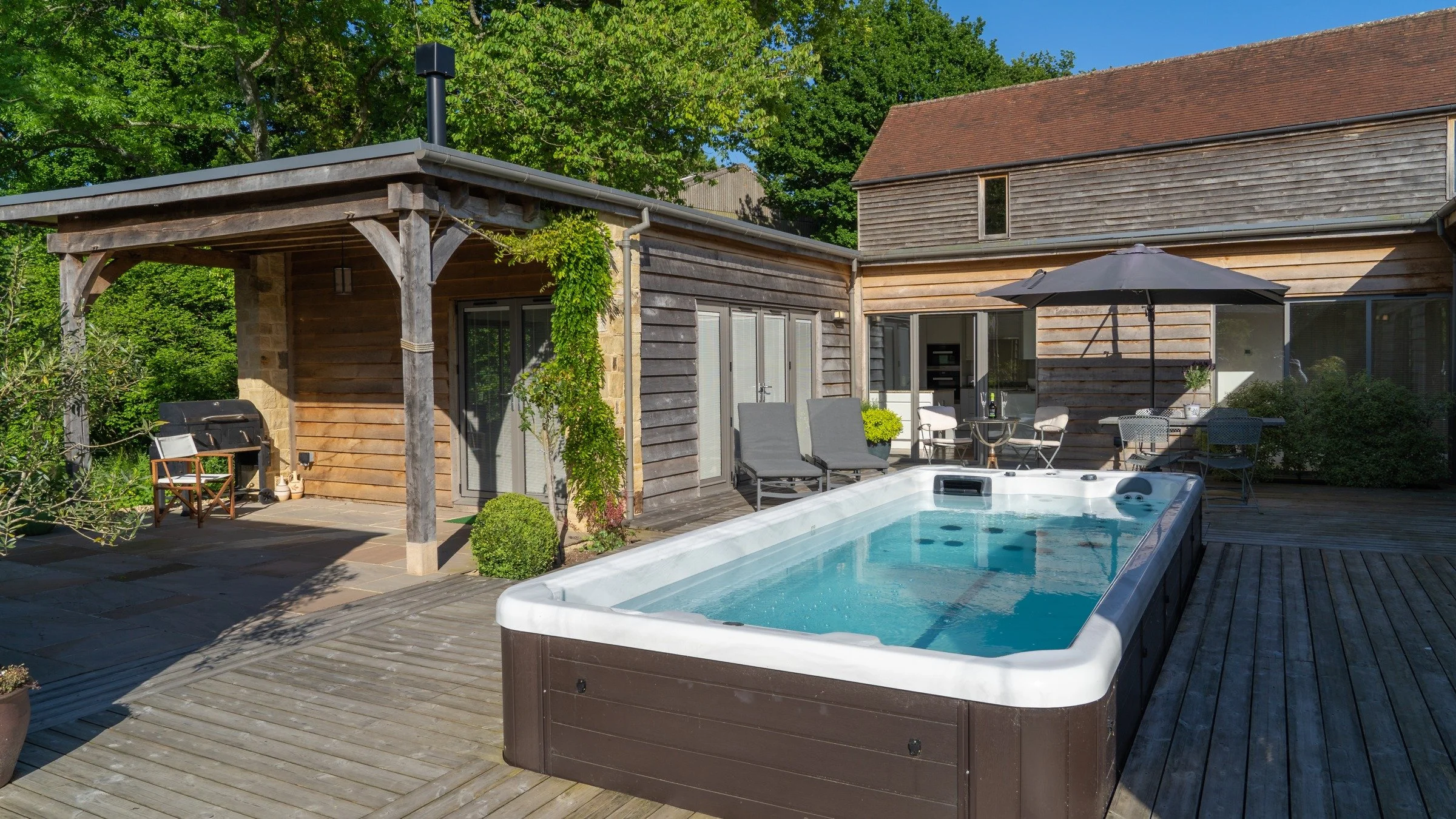 Explore Pool House: a brighter view across the courtyard towards the single-storey home.