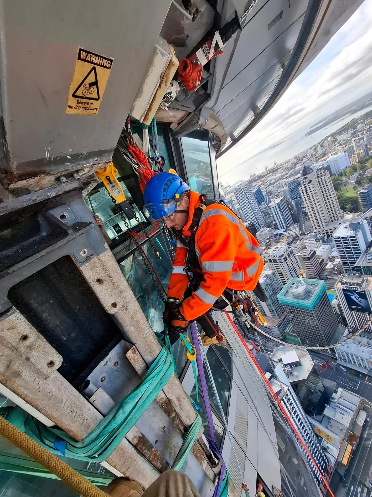Rope access technician working at height on a high-rise structure