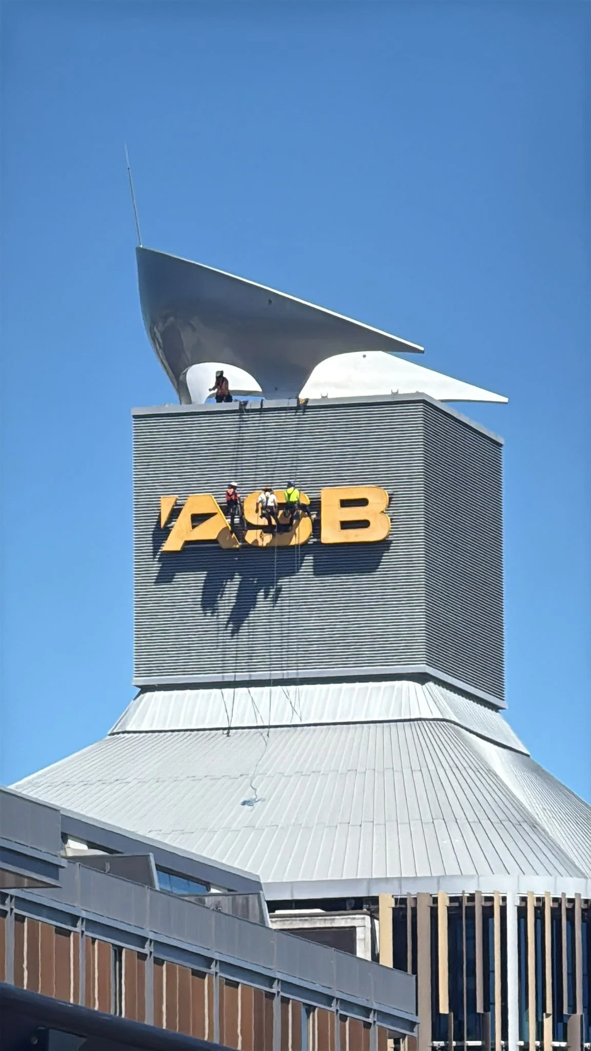 High-level commercial signage accessed for maintenance
