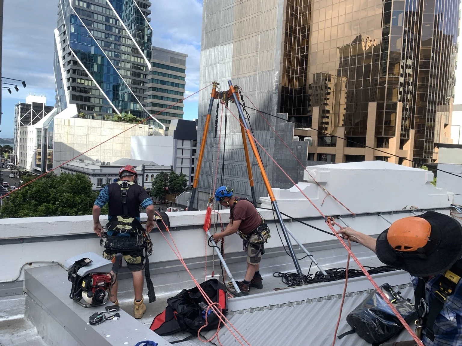 Rope access team preparing technical rigging on a rooftop