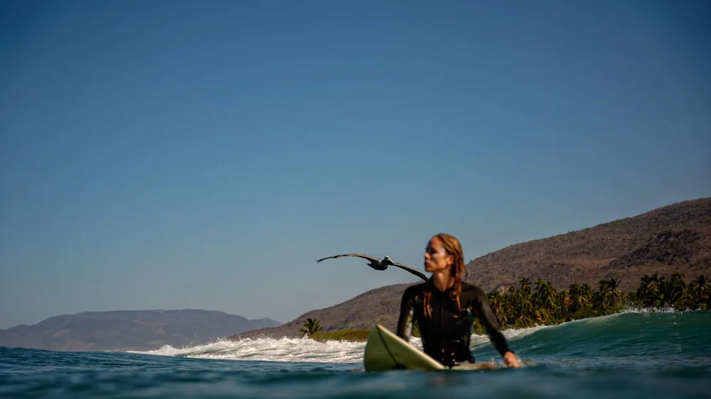Jenni in the lineup with a pelican flying past