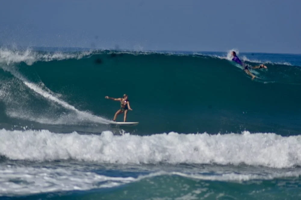Jenni surfing a wave