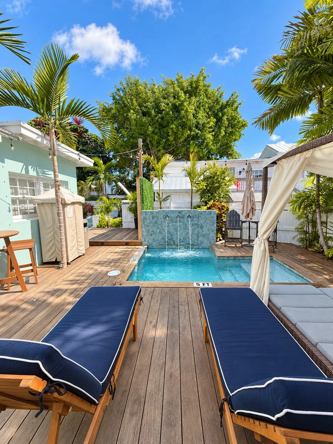 Heated pool and loungers shared by Lighthouse Suites guests