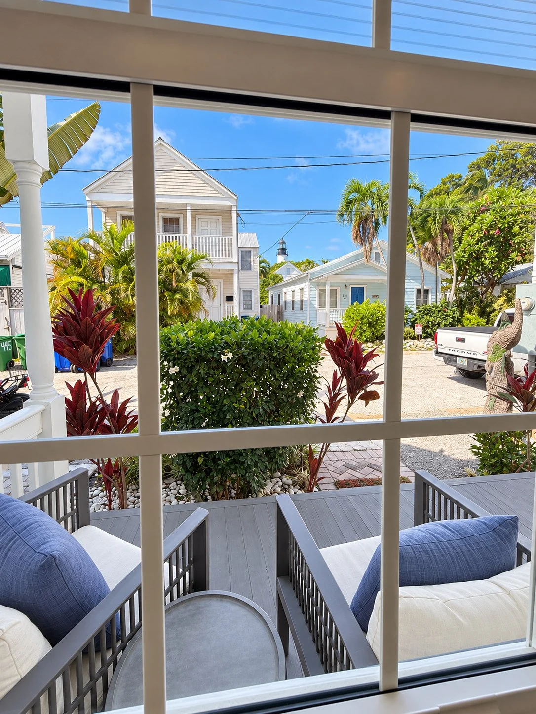 Furnished front porch viewed through the cottage window