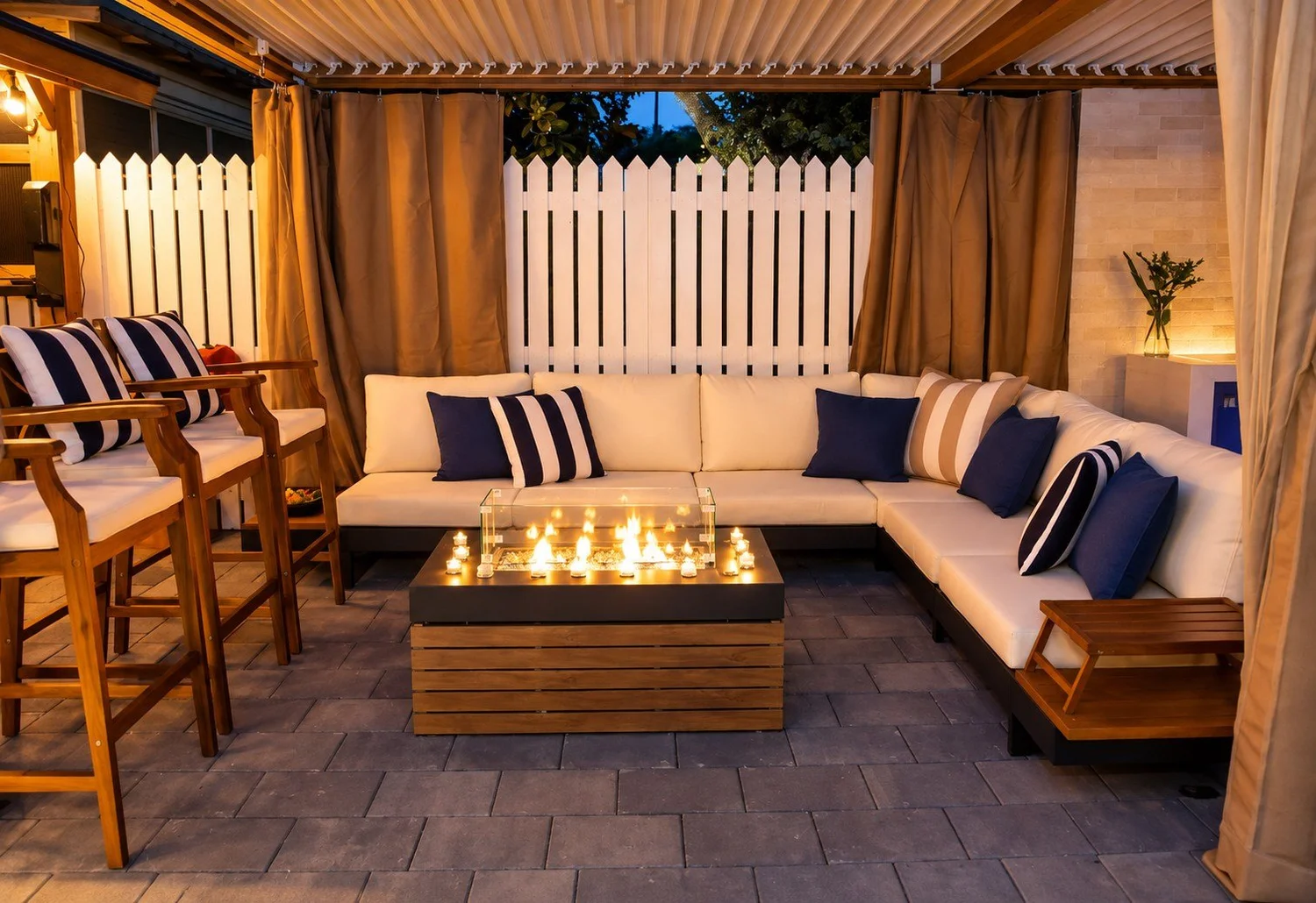 Evening pergola lounge with illuminated gas fire pit and an empty side table