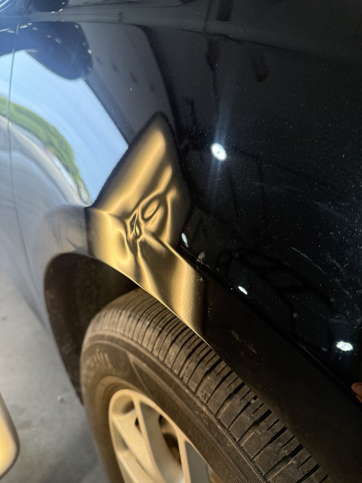 Black fender before paintless dent repair