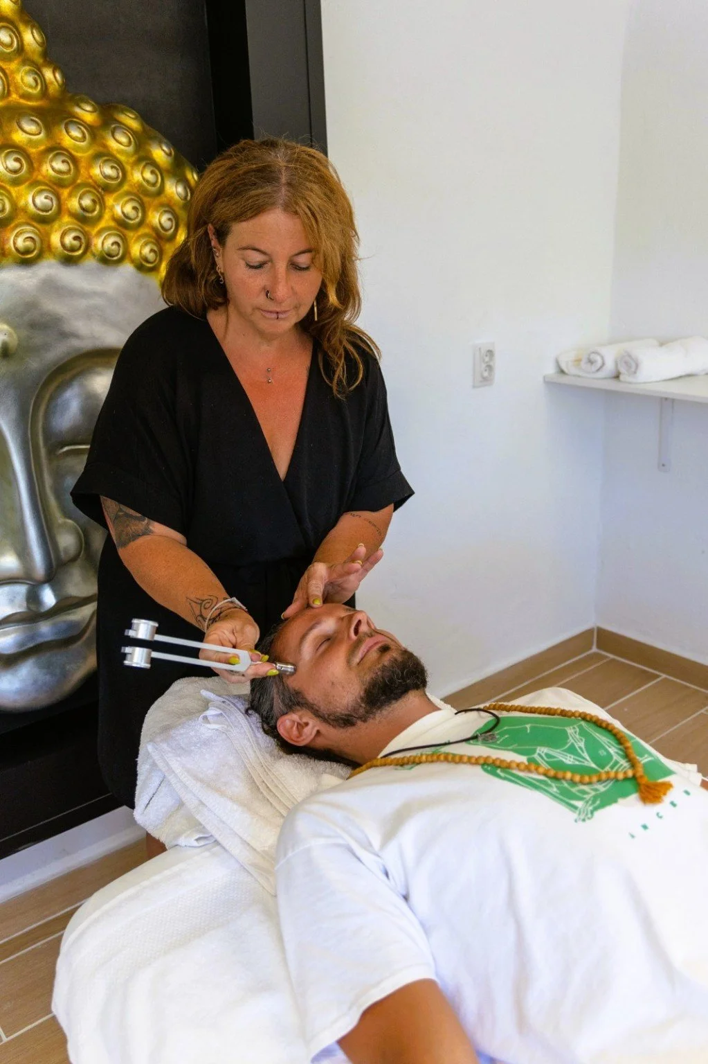Franny preparing a client for a sound-based treatment