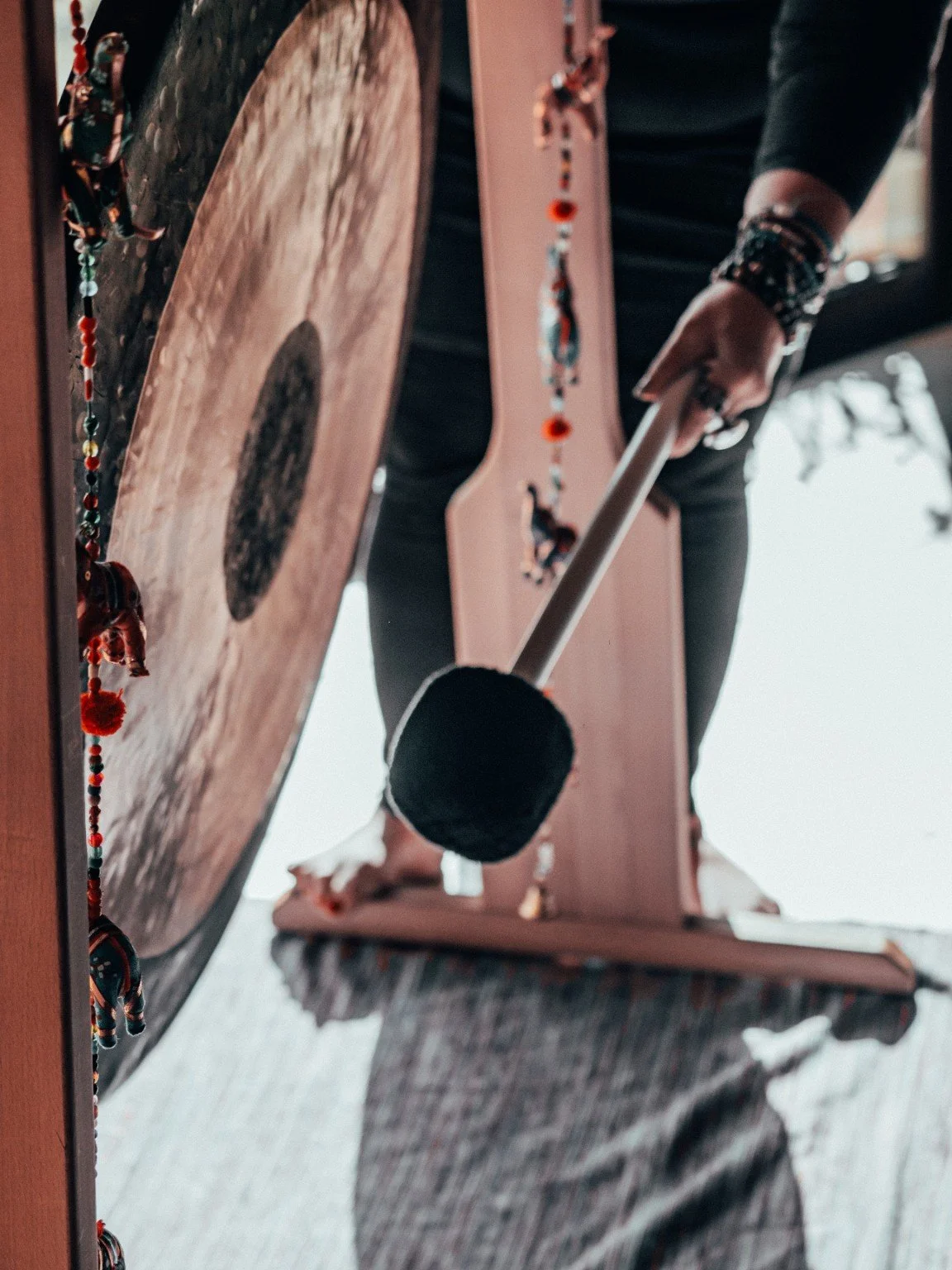 Franita holding space beside the gong during a pool session