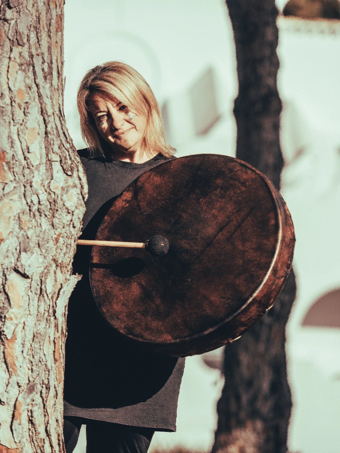 Franita with a large gong outdoors
