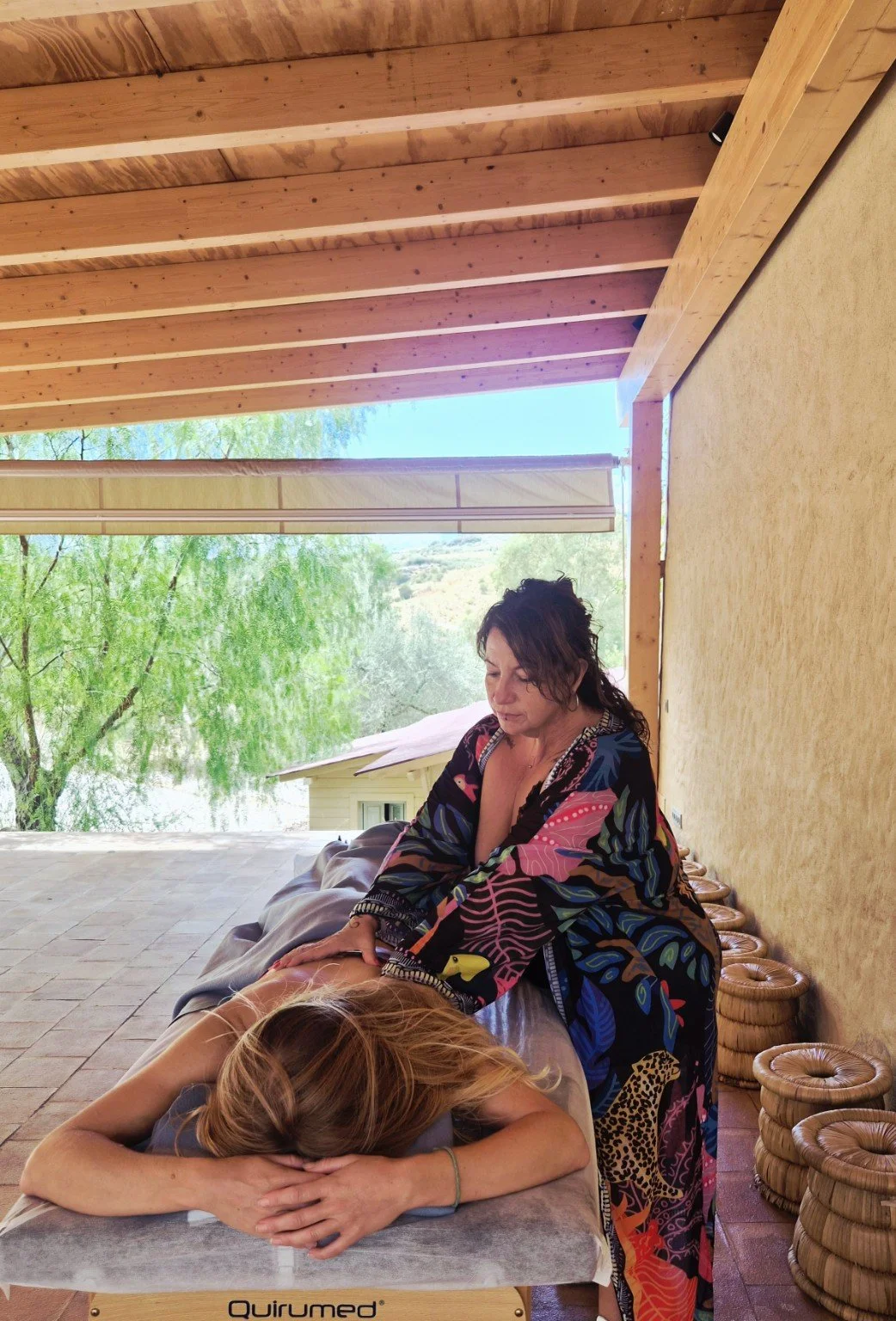 Franny with gong and instruments beside a pool