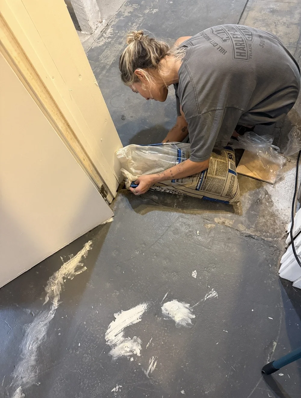 Me, pouring concrete patch along a basement doorway