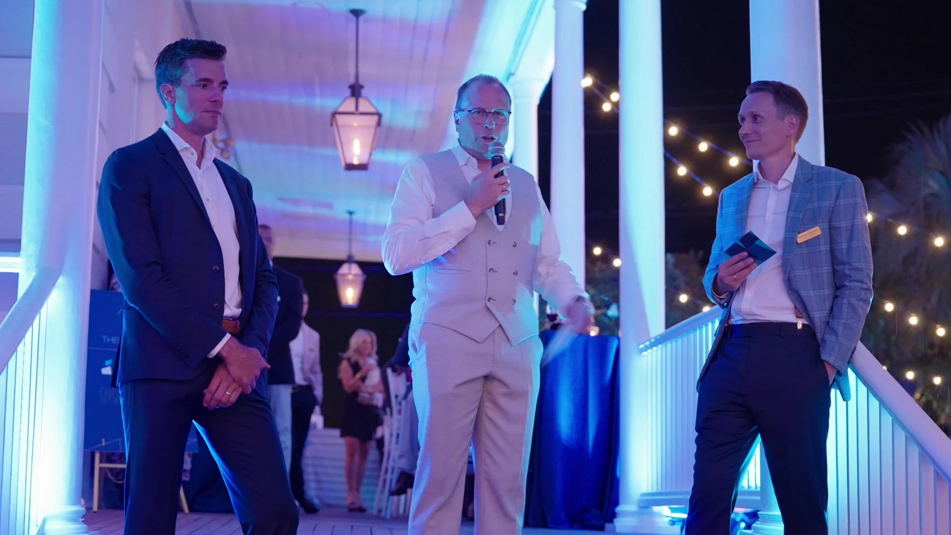 Night One: three speakers on the blue-lit veranda